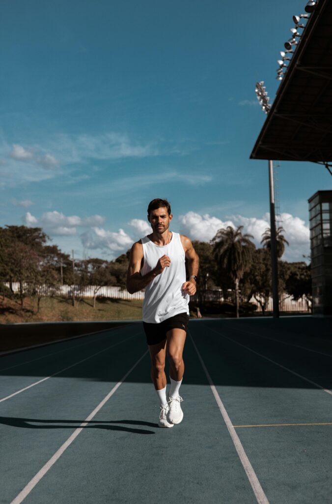 Runner at strong pace, mid-stride on trail or road
